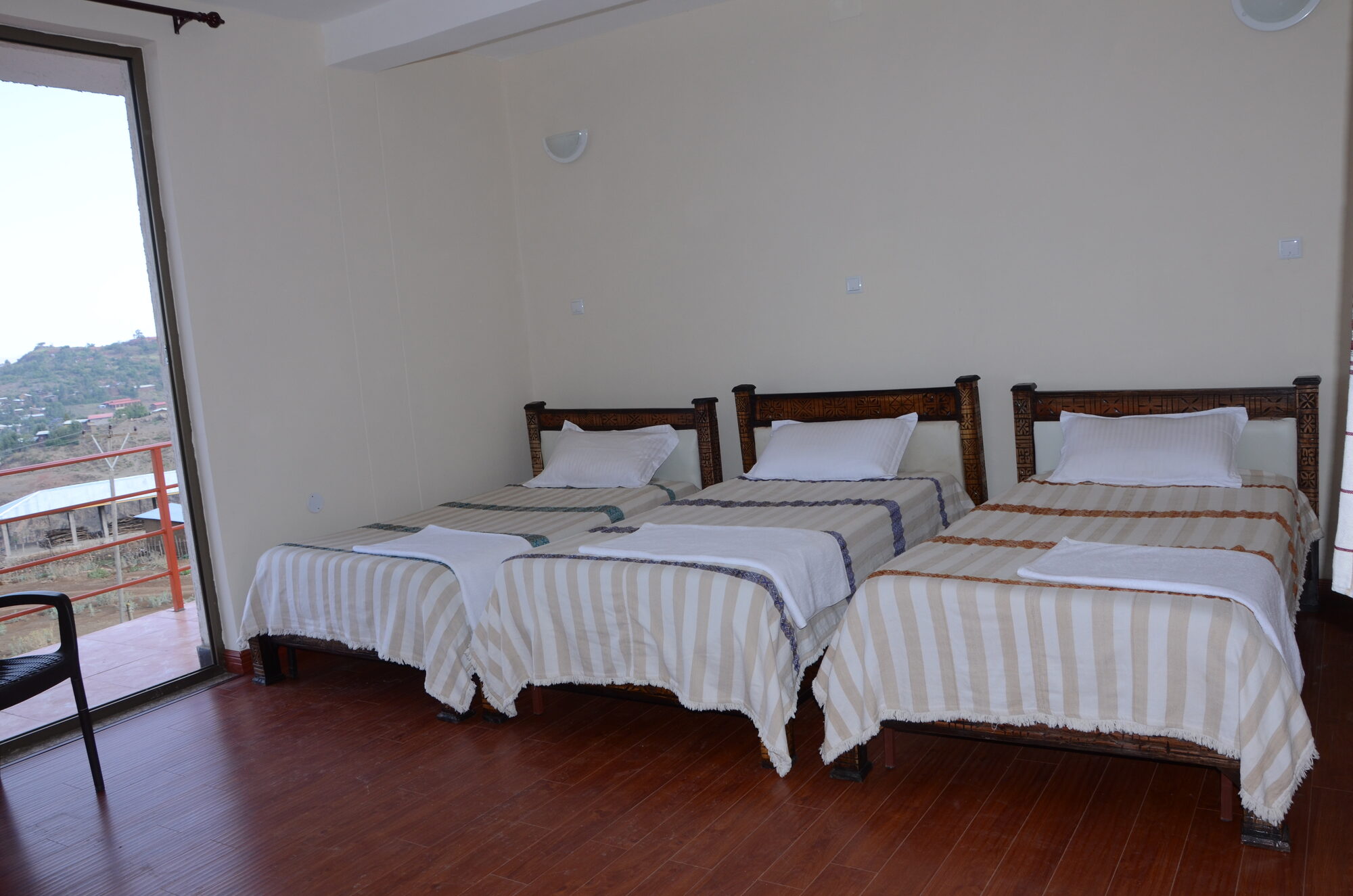 Clean, comfortable double room at Zan-Seyoum Hotel with mountain-facing balcony