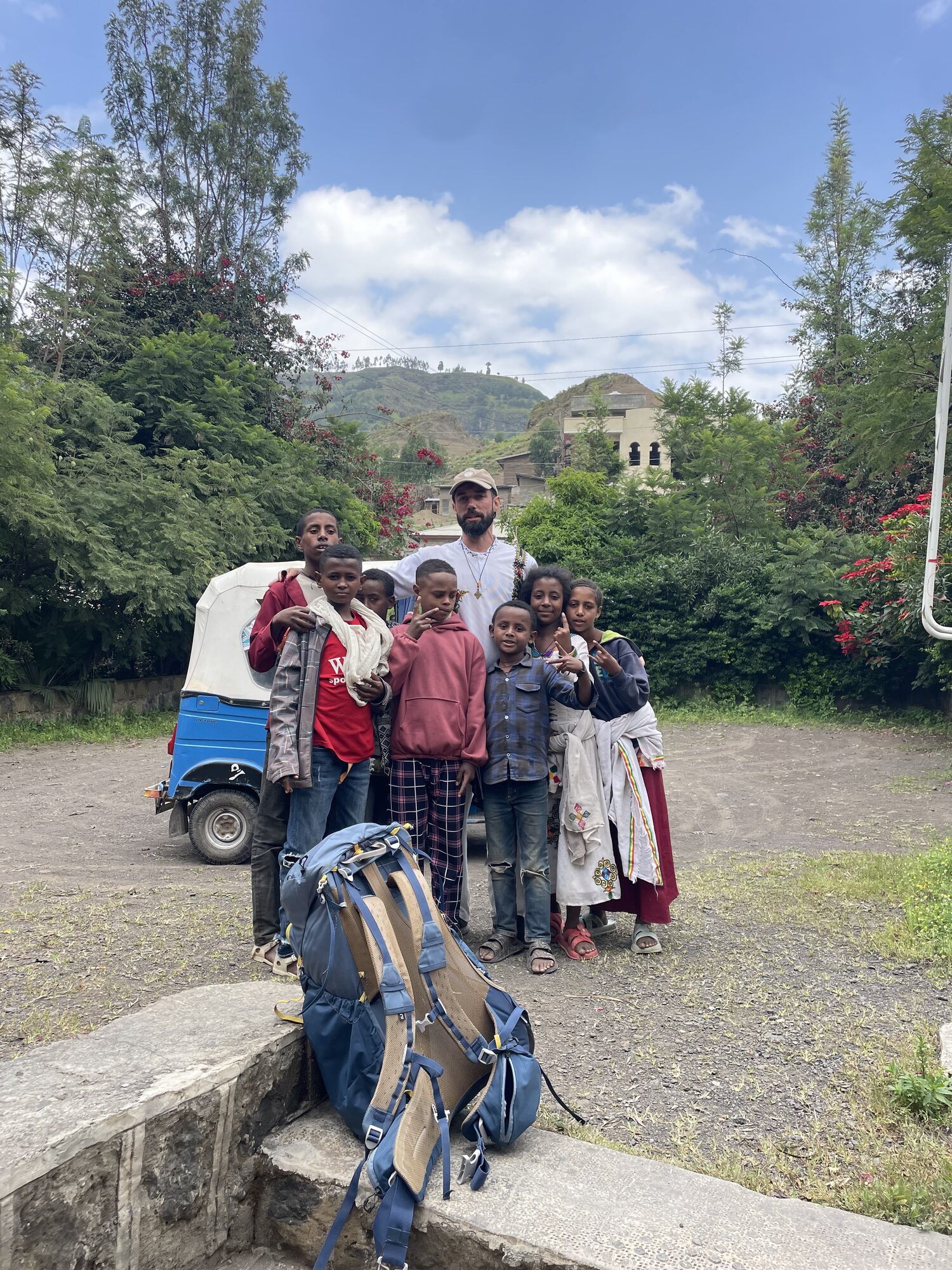 Antonin walking through Lalibela surrounded by local children