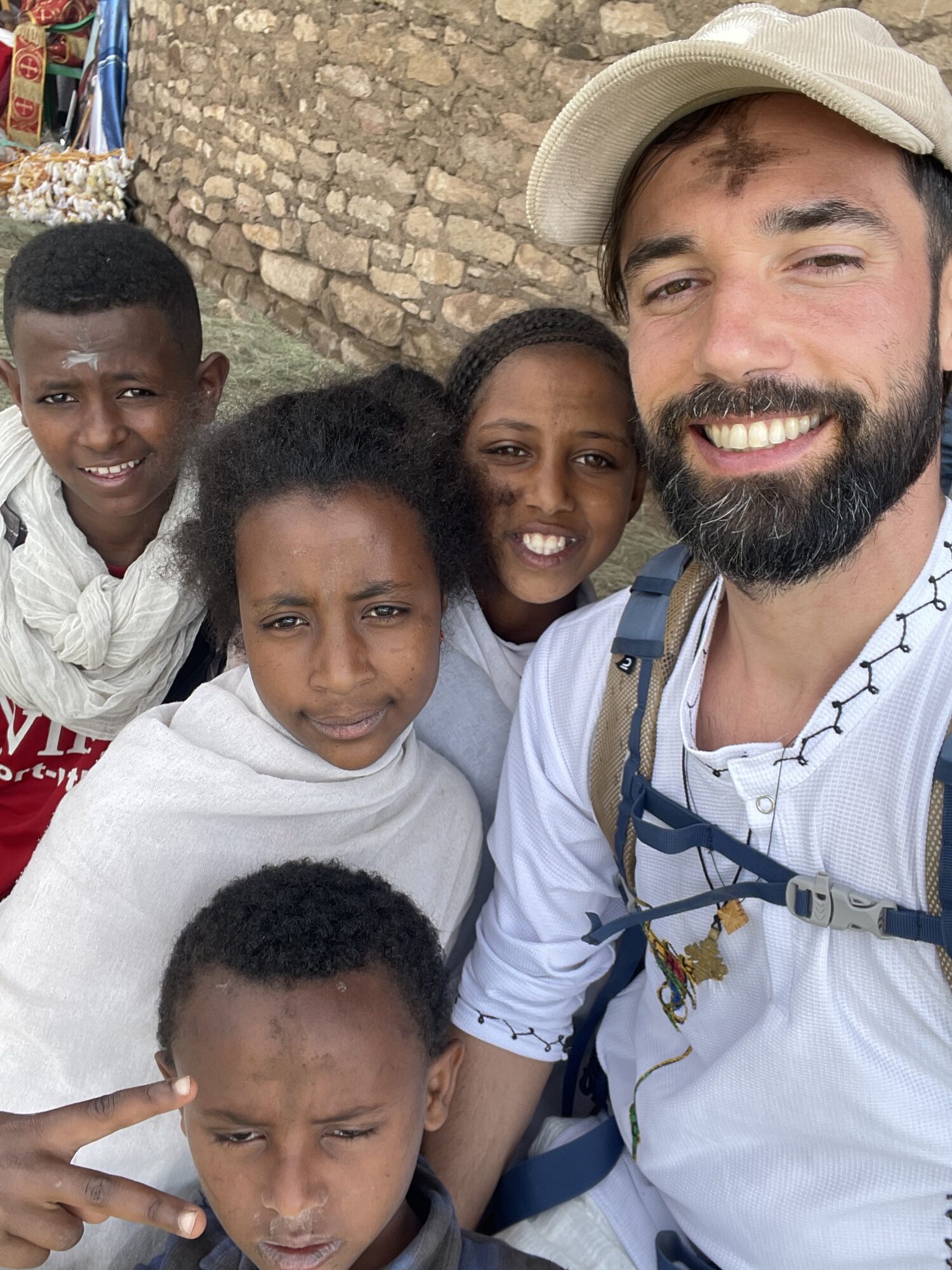 Antonin with children of Lalibela by a wall