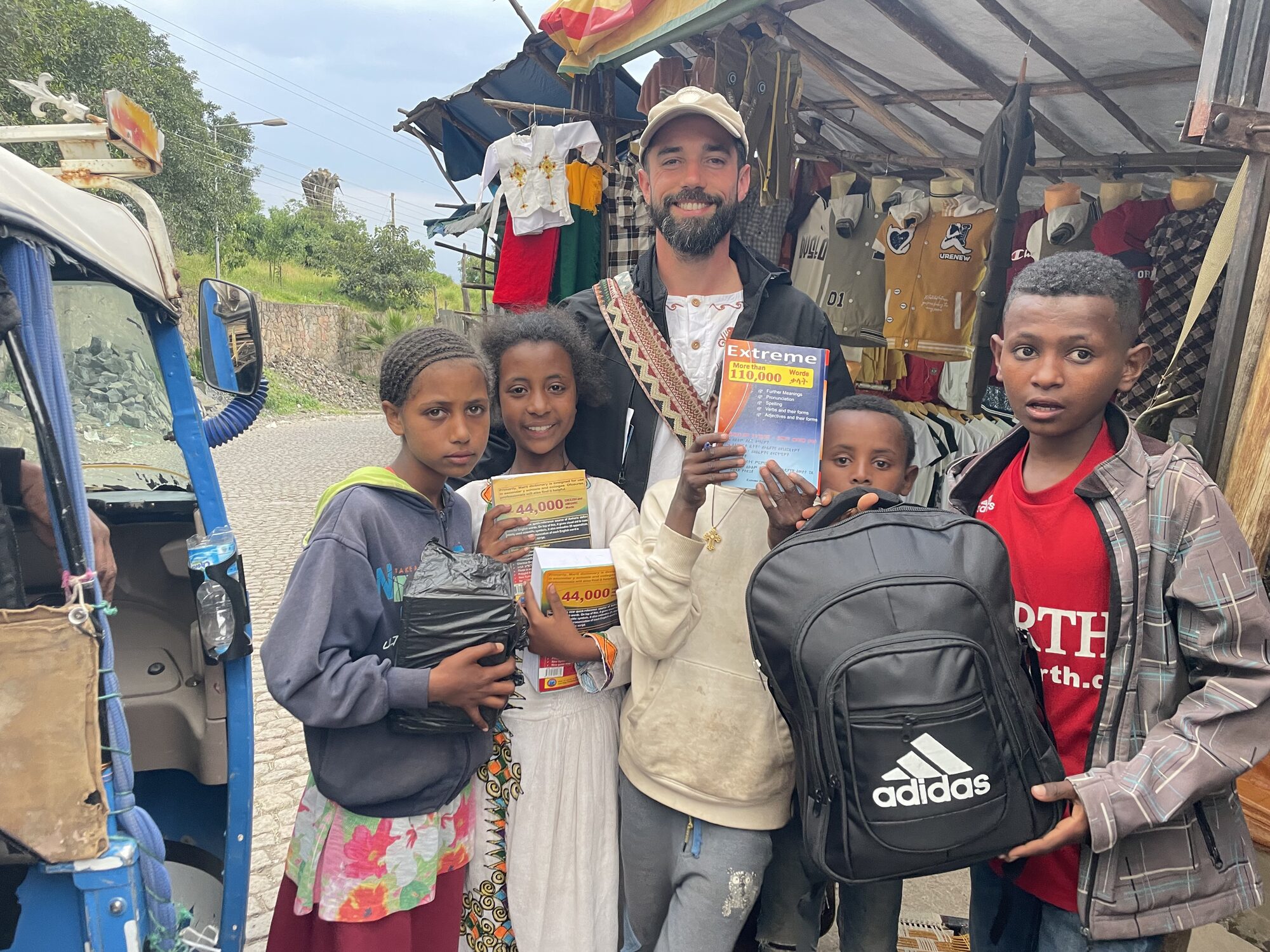 Giving school supplies to children at the market in Lalibela