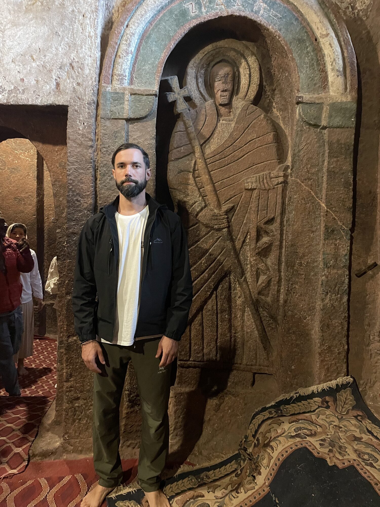 Antonin beside a saint carving in a Lalibela church