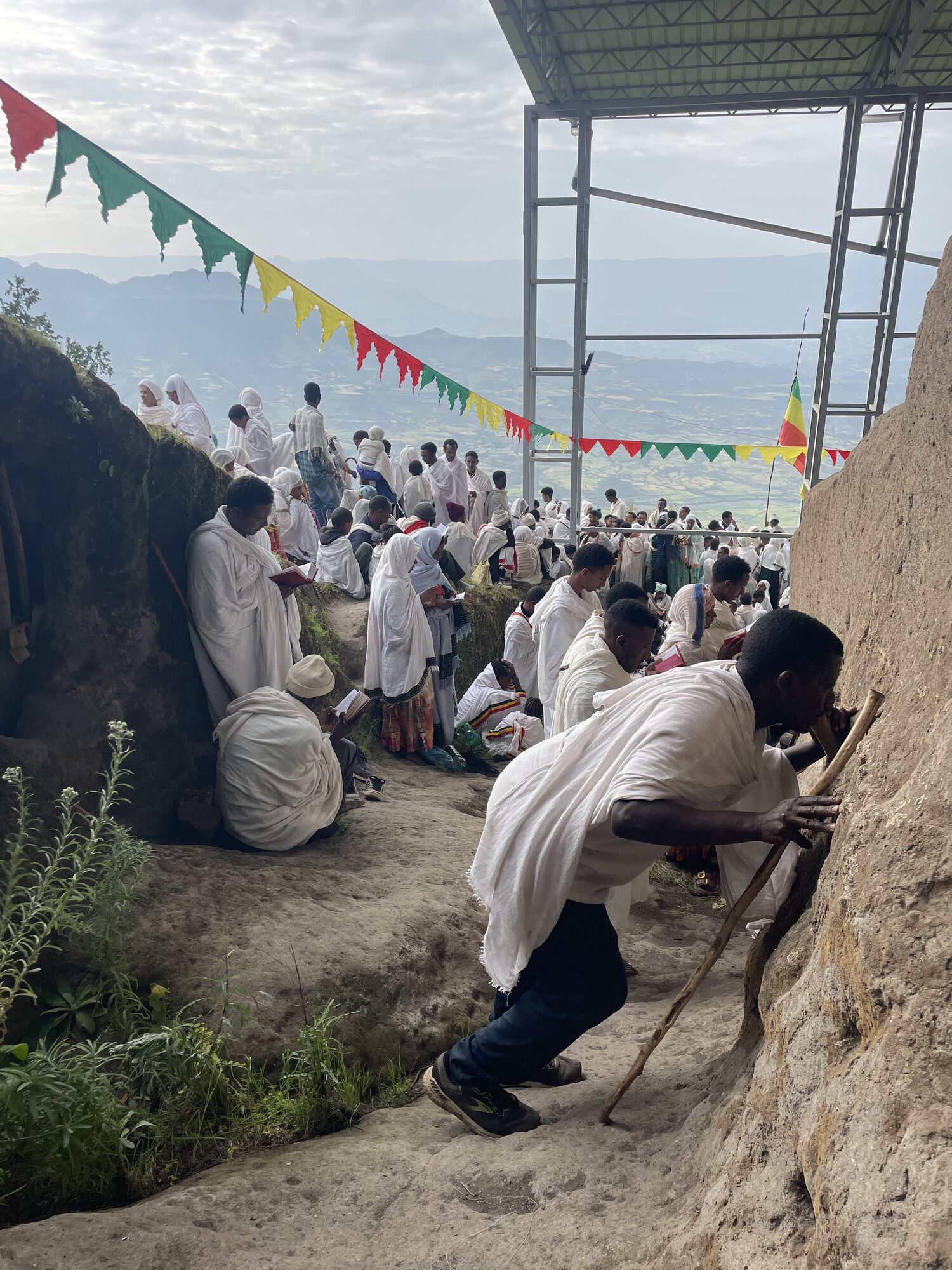 Worshippers gathered on the hillside near a Lalibela church
